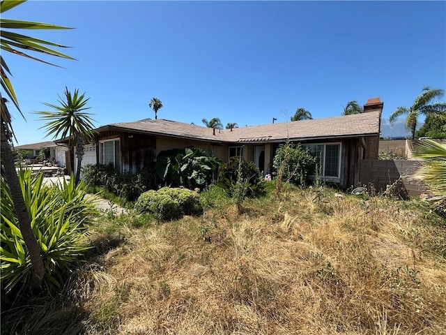 10164 Hampshire St, Rancho Cucamonga, CA 91730 - rear view of house with a chimney