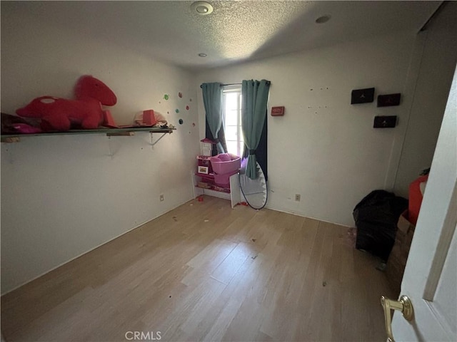 10164 Hampshire St, Rancho Cucamonga, CA 91730 - unfurnished bedroom with light wood finished floors and a textured ceiling