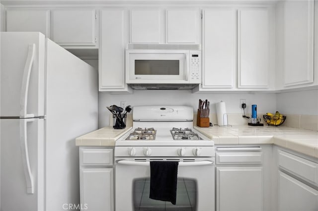 24461 Howes Dr, Laguna Niguel, CA 92677 - kitchen with white appliances, white cabinetry, and tile counters