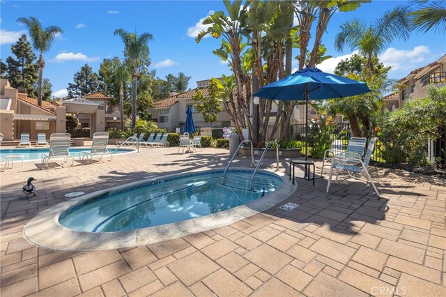 24461 Howes Dr, Laguna Niguel, CA 92677 - community pool featuring a hot tub, a patio area, and a residential view