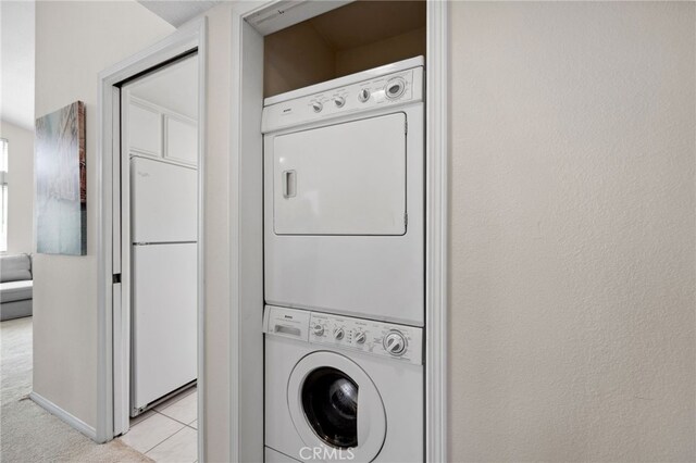 24461 Howes Dr, Laguna Niguel, CA 92677 - laundry room with estacked washer and dryer, light tile patterned floors, and light carpet