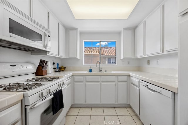 24461 Howes Dr, Laguna Niguel, CA 92677 - kitchen with white appliances, white cabinets, tile countertops, and light tile patterned floors