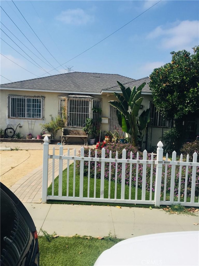 3424 Hill St, Huntington Park, CA 90255 - ranch-style home featuring a fenced front yard, stucco siding, and a shingled roof