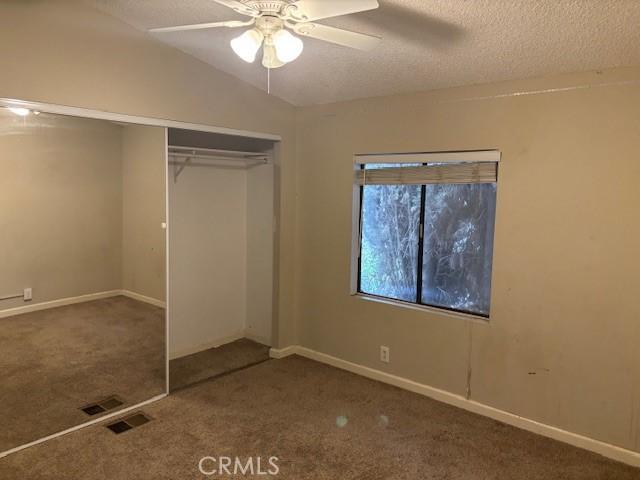 10450 Stageline St, Corona, CA 92883 - unfurnished bedroom with carpet floors, a closet, a textured ceiling, and a ceiling fan