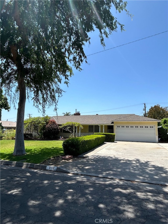 8159 Strub Ave, Whittier, CA 90602 - ranch-style house with a garage, driveway, and a front lawn