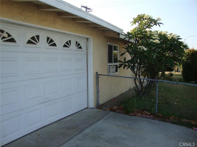 2100 W Dogwood Ave, Anaheim, CA 92801 - garage featuring concrete driveway and cooling unit