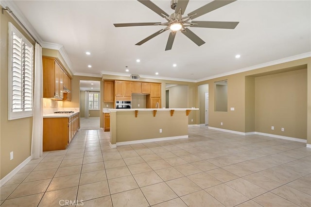 11529 Trailrun Ct, Riverside, CA 92505 - kitchen with crown molding, a center island, a ceiling fan, oven, and light countertops