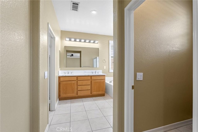 11529 Trailrun Ct, Riverside, CA 92505 - full bathroom with a bath, double vanity, tile patterned floors, and a textured wall