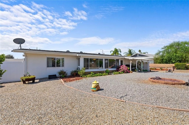 25890 Roanoke Rd, Menifee, CA 92586 - rear view of property with stucco siding and a sunroom