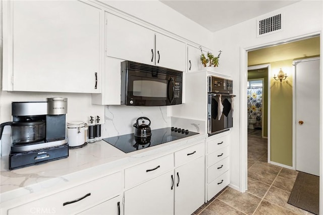 25890 Roanoke Rd, Menifee, CA 92586 - kitchen featuring black appliances, white cabinetry, light stone countertops, and light tile patterned floors