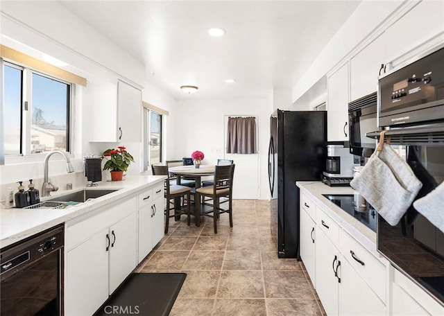 25890 Roanoke Rd, Menifee, CA 92586 - kitchen with black appliances, white cabinets, recessed lighting, and light countertops