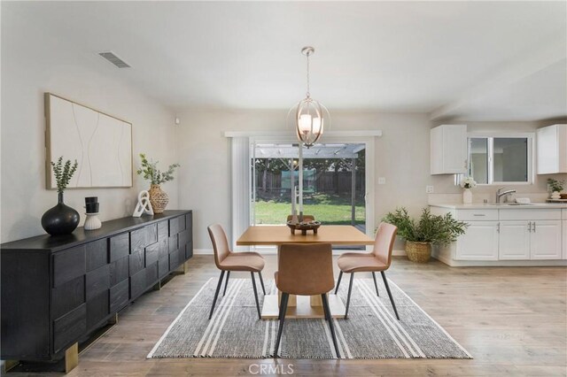 21237 Silver Cloud Dr, Diamond Bar, CA 91765 - dining area with light wood-type flooring and a chandelier
