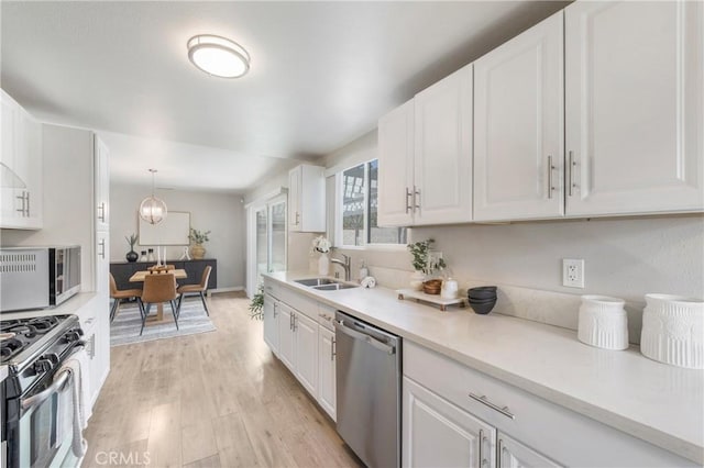 21237 Silver Cloud Dr, Diamond Bar, CA 91765 - kitchen featuring appliances with stainless steel finishes, white cabinetry, light wood-style flooring, and light countertops