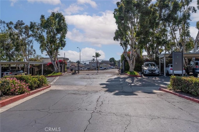 3555 Grove St Unit 231, Lemon Grove, CA 91945 - view of asphalt street with street lighting, a gate, curbs, and a gated entry