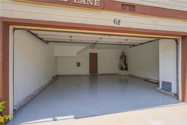 8939 Gallatin Rd Unit 68, Pico Rivera, CA 90660 - garage with baseboards and a garage door opener