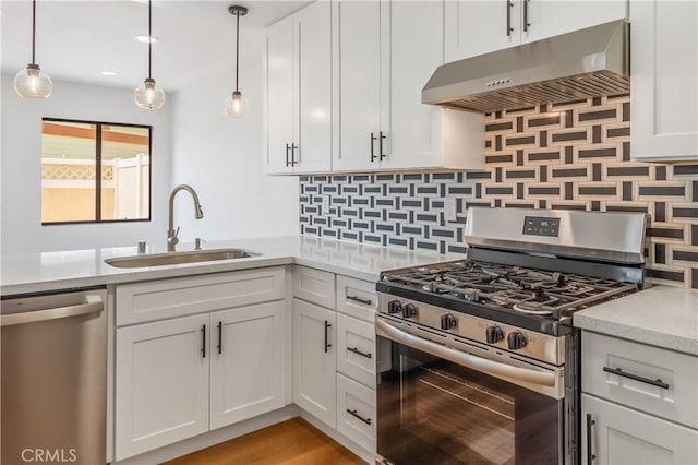 8939 Gallatin Rd Unit 68, Pico Rivera, CA 90660 - kitchen with appliances with stainless steel finishes, under cabinet range hood, backsplash, and white cabinets