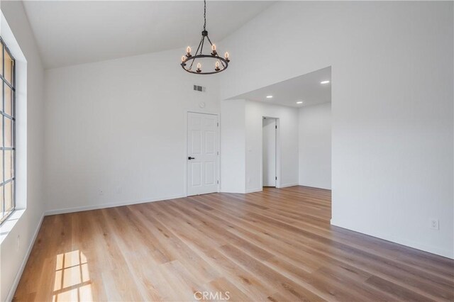 8939 Gallatin Rd Unit 68, Pico Rivera, CA 90660 - spare room with a chandelier, light wood-style floors, high vaulted ceiling, and recessed lighting