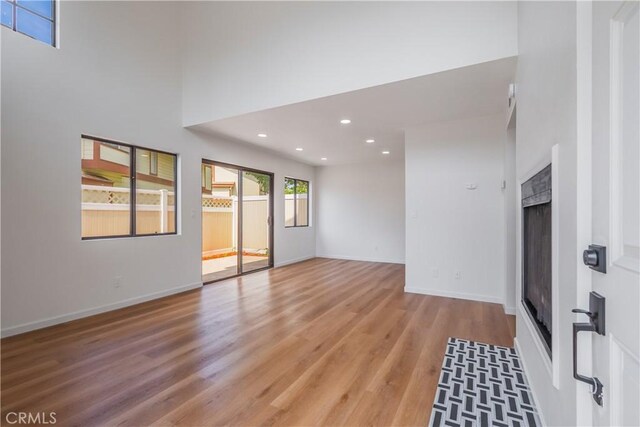 8939 Gallatin Rd Unit 68, Pico Rivera, CA 90660 - empty room featuring light wood finished floors, recessed lighting, and a fireplace