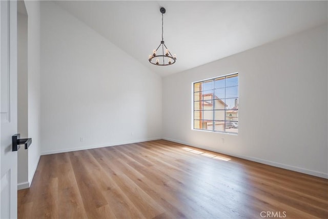 8939 Gallatin Rd Unit 68, Pico Rivera, CA 90660 - empty room featuring a chandelier, vaulted ceiling, and wood finished floors