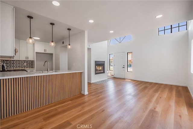 8939 Gallatin Rd Unit 68, Pico Rivera, CA 90660 - kitchen with light countertops, hanging light fixtures, recessed lighting, a peninsula, and backsplash
