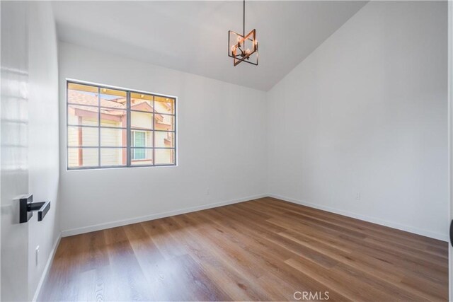 8939 Gallatin Rd Unit 68, Pico Rivera, CA 90660 - unfurnished room with wood finished floors, a chandelier, and lofted ceiling