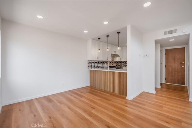 8939 Gallatin Rd Unit 68, Pico Rivera, CA 90660 - kitchen featuring tasteful backsplash, light countertops, range, recessed lighting, and light wood-style floors
