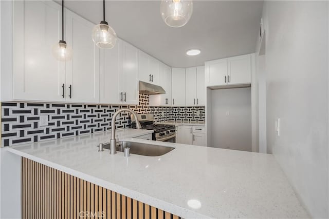 8939 Gallatin Rd Unit 68, Pico Rivera, CA 90660 - kitchen with under cabinet range hood, gas stove, a peninsula, and decorative backsplash
