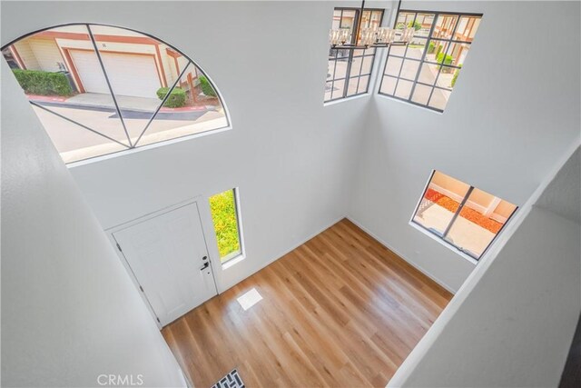 8939 Gallatin Rd Unit 68, Pico Rivera, CA 90660 - foyer with wood finished floors, a high ceiling, healthy amount of natural light, and a chandelier