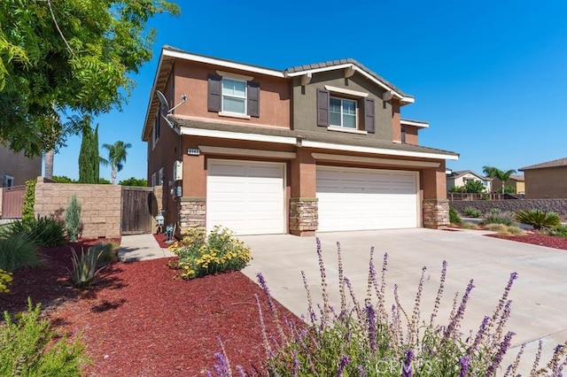 9142 San Luis Obispo Ln, Riverside, CA 92508 - view of front of property featuring stone siding, an attached garage, stucco siding, and driveway