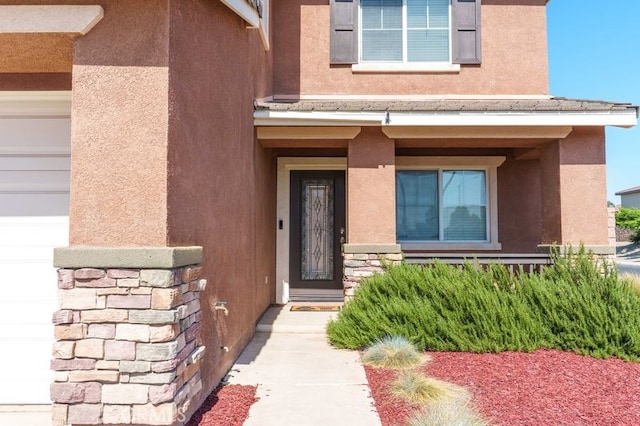 9142 San Luis Obispo Ln, Riverside, CA 92508 - property entrance with stucco siding, stone siding, and an attached garage