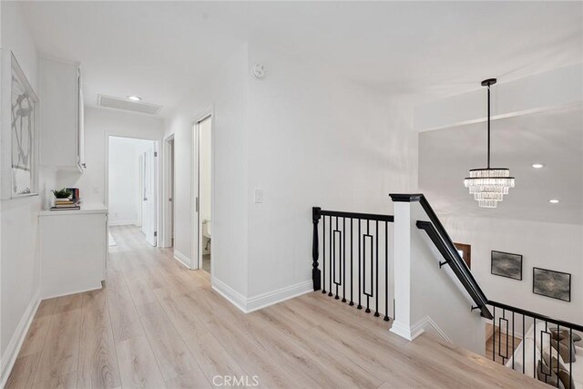 6137 Rustling Oaks Dr, Agoura Hills, CA 91301 - hall with an upstairs landing, light wood-style floors, recessed lighting, and a chandelier