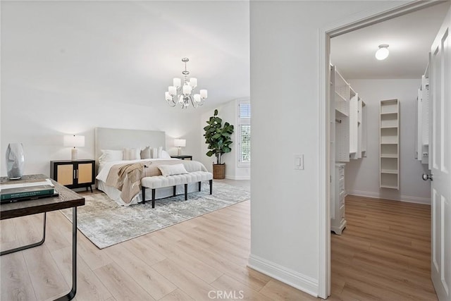 6137 Rustling Oaks Dr, Agoura Hills, CA 91301 - bedroom with light wood-style floors, a chandelier, and a spacious closet