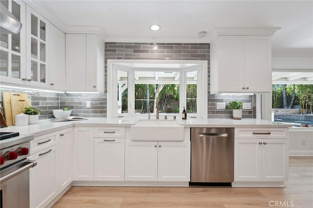 6137 Rustling Oaks Dr, Agoura Hills, CA 91301 - kitchen featuring stainless steel appliances, white cabinets, light countertops, decorative backsplash, and crown molding