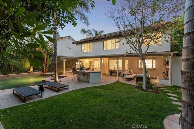 6137 Rustling Oaks Dr, Agoura Hills, CA 91301 - rear view of property with outdoor lounge area, a yard, stucco siding, and a patio