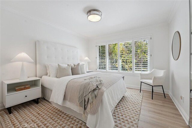 6137 Rustling Oaks Dr, Agoura Hills, CA 91301 - bedroom with ornamental molding and light wood-style flooring