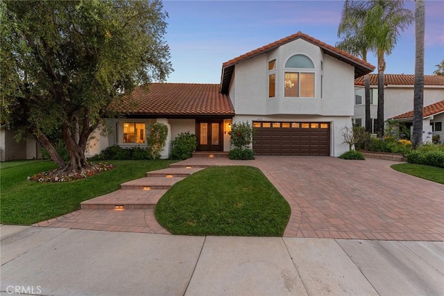 6137 Rustling Oaks Dr, Agoura Hills, CA 91301 - mediterranean / spanish home with french doors, decorative driveway, a garage, and a yard