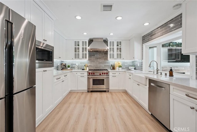 6137 Rustling Oaks Dr, Agoura Hills, CA 91301 - kitchen featuring stainless steel appliances, extractor fan, backsplash, light wood-style flooring, and recessed lighting