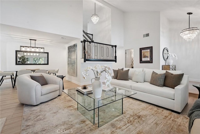 6137 Rustling Oaks Dr, Agoura Hills, CA 91301 - living area with a chandelier, high vaulted ceiling, stairway, and wood finished floors