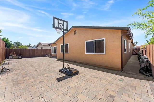 8950 Brentford Ave, San Diego, CA 92126 - back of property with a fenced backyard, stucco siding, and a patio