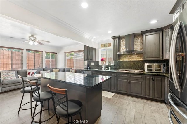 8950 Brentford Ave, San Diego, CA 92126 - kitchen with wall chimney range hood, stainless steel appliances, a kitchen bar, open floor plan, and a center island