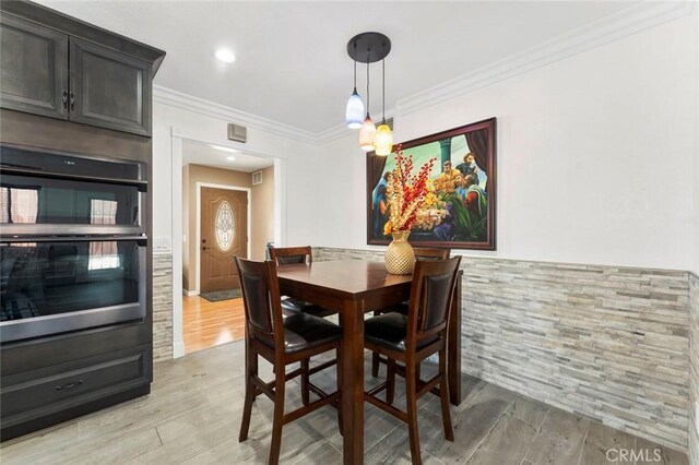 8950 Brentford Ave, San Diego, CA 92126 - dining space featuring light wood-style floors and ornamental molding