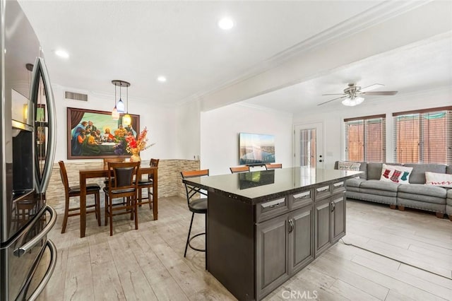 8950 Brentford Ave, San Diego, CA 92126 - kitchen featuring stainless steel fridge, light wood-type flooring, a kitchen island, a ceiling fan, and open floor plan