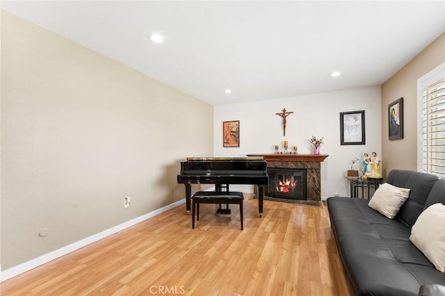 8950 Brentford Ave, San Diego, CA 92126 - sitting room featuring light wood finished floors, a glass covered fireplace, and recessed lighting