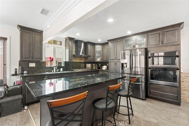 8950 Brentford Ave, San Diego, CA 92126 - kitchen with wall chimney range hood, stainless steel appliances, crown molding, decorative backsplash, and light wood finished floors