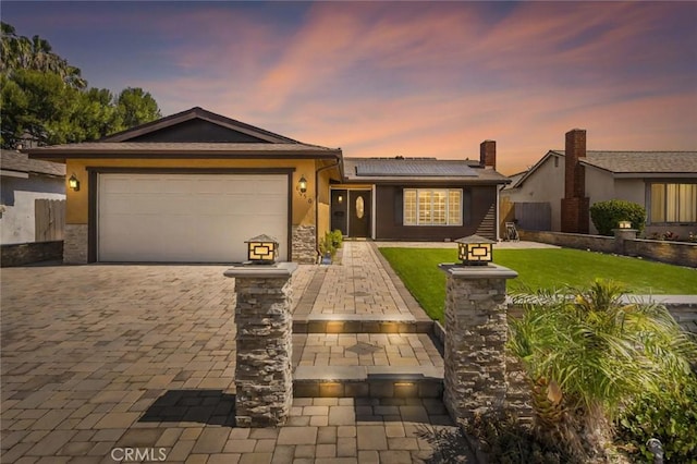 8950 Brentford Ave, San Diego, CA 92126 - ranch-style home with solar panels, an attached garage, decorative driveway, and stucco siding