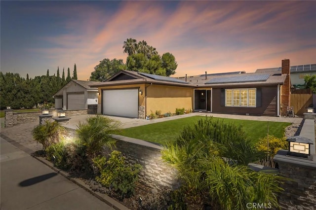 8950 Brentford Ave, San Diego, CA 92126 - ranch-style home with concrete driveway, solar panels, a garage, and stone siding