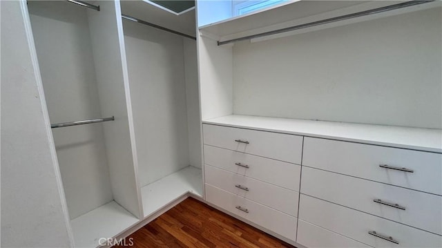 15936 Osborne St, North Hills, CA 91343 - walk in closet featuring dark wood-style flooring