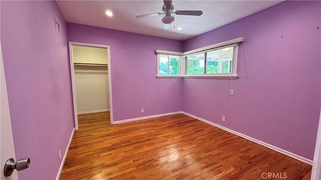 15936 Osborne St, North Hills, CA 91343 - unfurnished bedroom featuring wood finished floors, a walk in closet, a closet, and ceiling fan