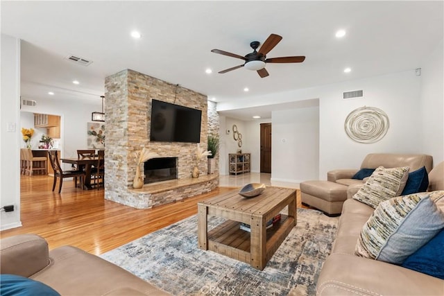 15936 Osborne St, North Hills, CA 91343 - living area with ceiling fan, wood finished floors, recessed lighting, and a stone fireplace
