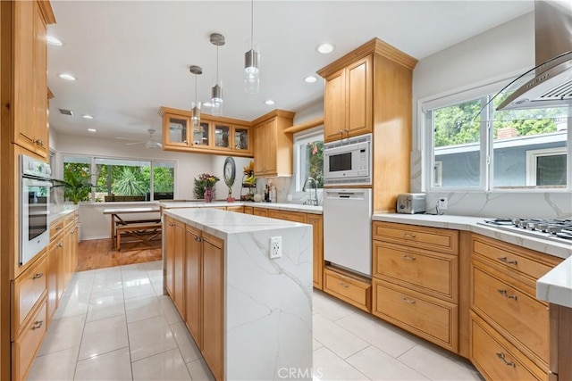 15936 Osborne St, North Hills, CA 91343 - kitchen with white appliances, wall chimney exhaust hood, tasteful backsplash, a peninsula, and light tile patterned flooring